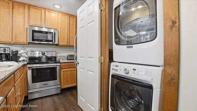 a kitchen with a stove a washer and dryer