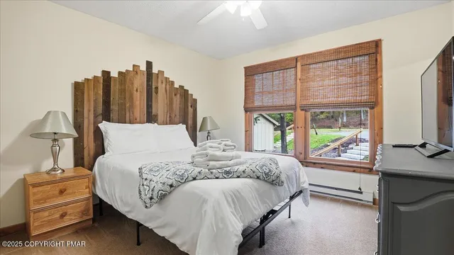 a bedroom with a bed and a large window