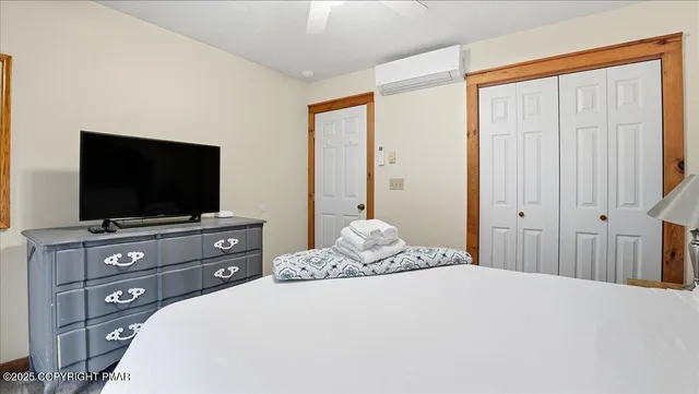 a bedroom with a bed and a flat screen tv
