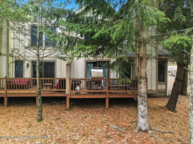 a view of a house with large pool and sitting area
