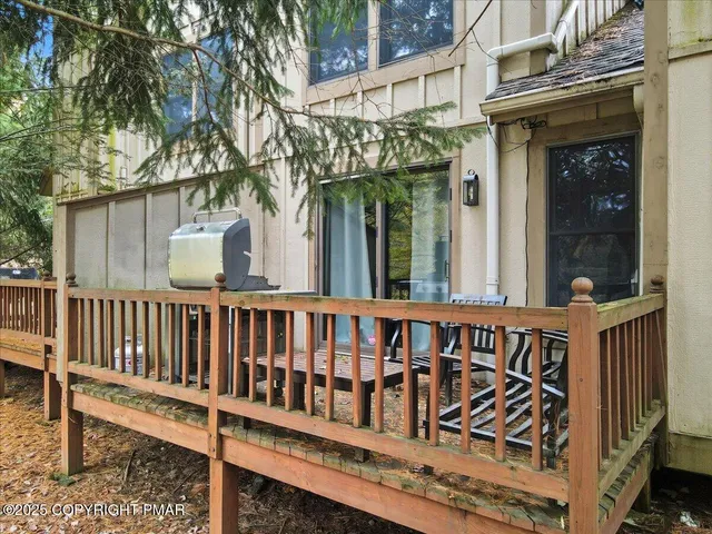 a view of a wooden house with large windows