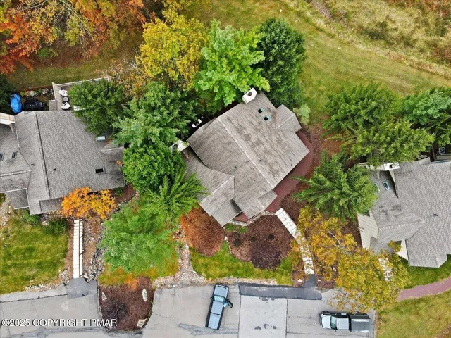an aerial view of a house with a yard