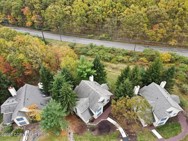 aerial view of a house with a yard and lake view