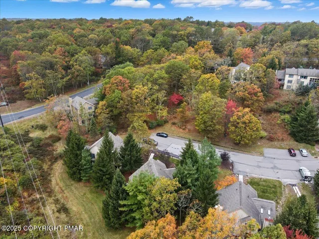 an aerial view of a houses with a yard