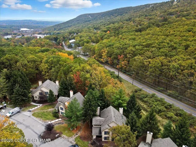 an aerial view of a house with a yard