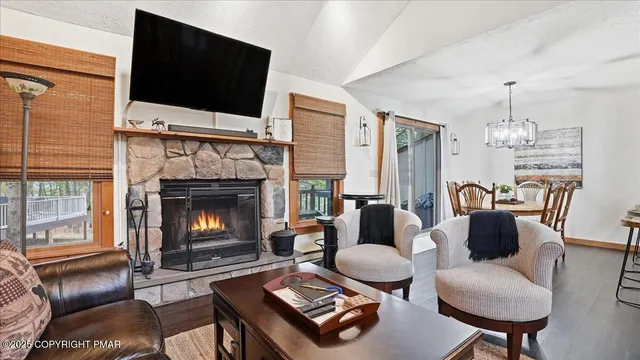 a living room with furniture fireplace and flat screen tv
