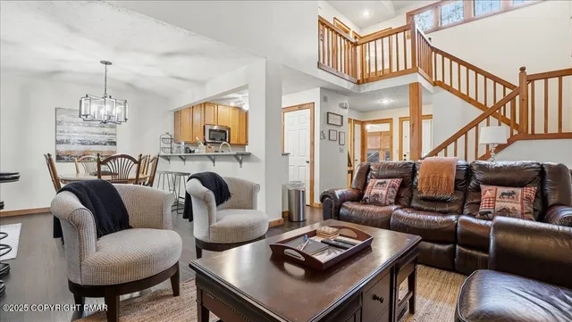 a living room with furniture and a chandelier