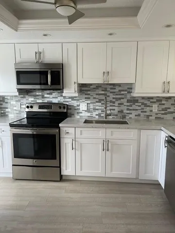 a kitchen with stainless steel appliances granite countertop a stove and a sink
