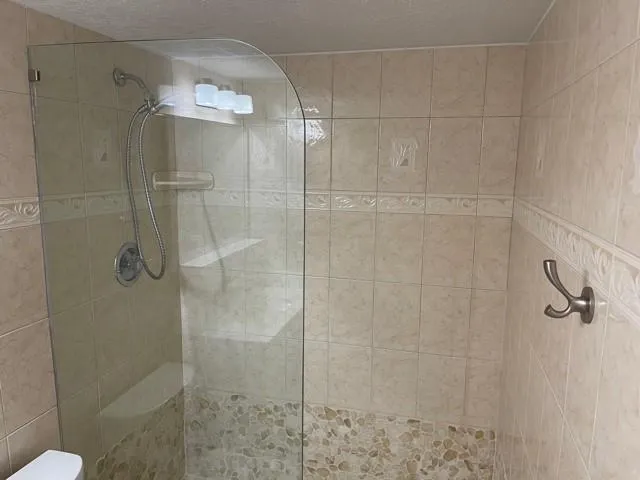 a bathroom with a glass shower door