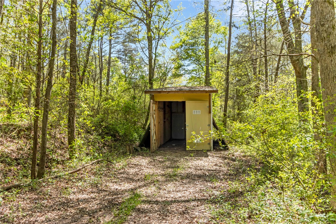 2312 Old Pendleton Road Easley, SC 29642 - Photo 15 of 16 A rustic outbuilding sits nestled among vibrant foliage.