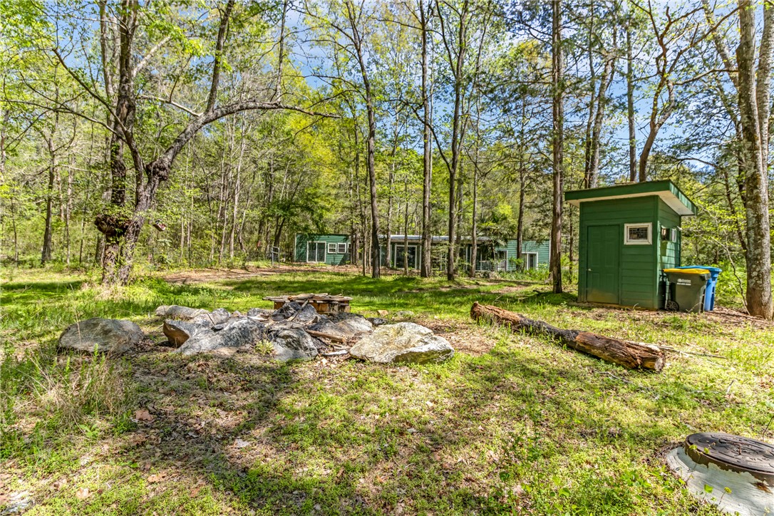 2312 Old Pendleton Road Easley, SC 29642 - Photo 7 of 16 A tranquil woodsy setting with a charming outbuilding and outdoor recreation.