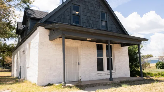 a view of a house with a wooden fence