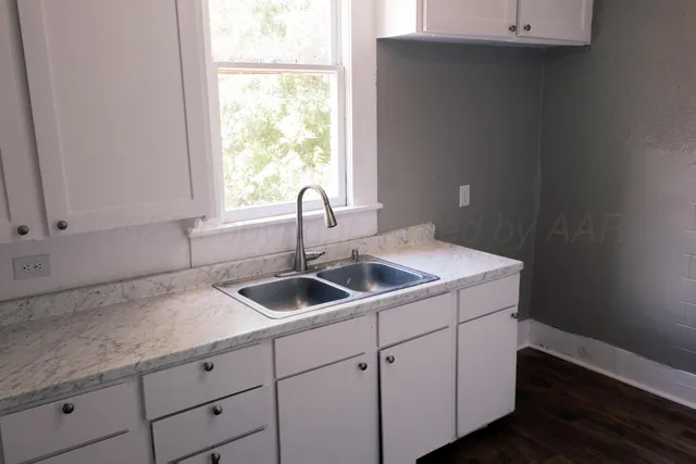 a kitchen with a sink and cabinets