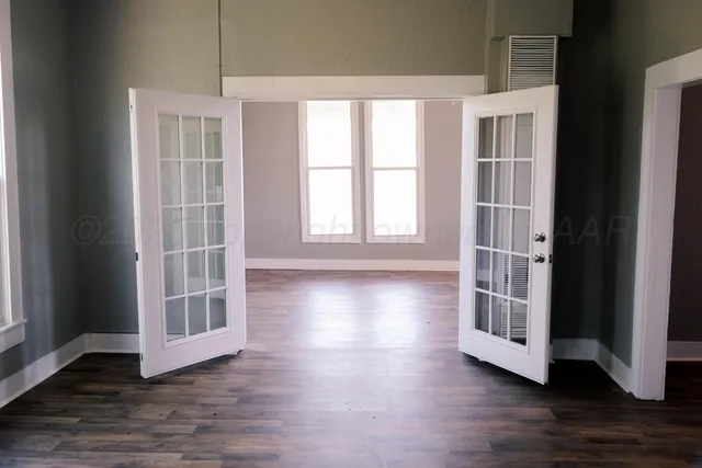 a view of a kitchen with wooden floor and window