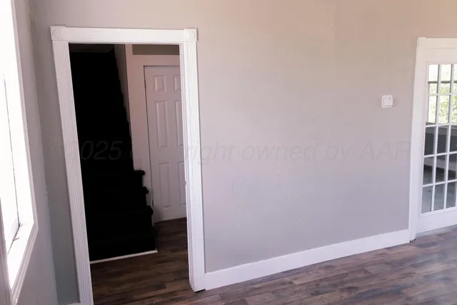 a view of front door with wooden floor