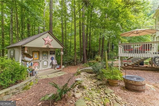 a view of a house with a yard and wooden fence