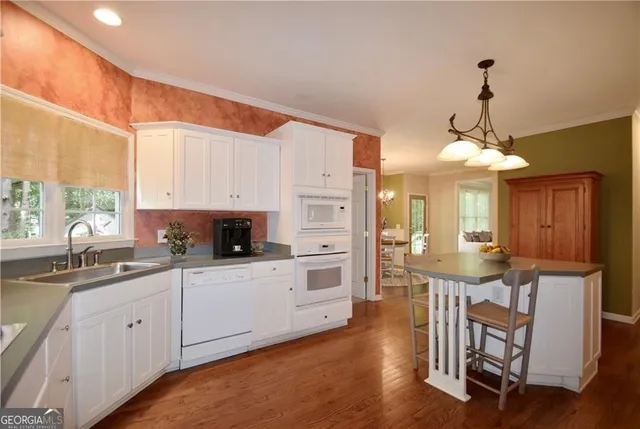 a kitchen with white cabinets and white appliances