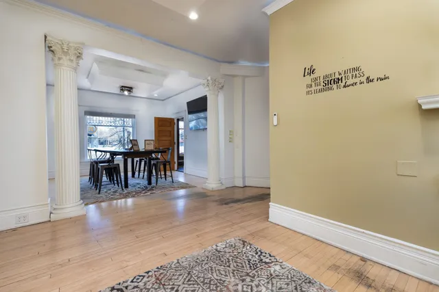 a view of a dining room with furniture and wooden floor