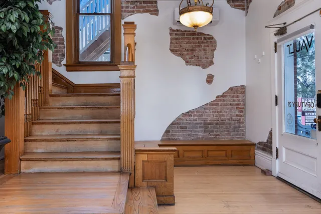 a view of entryway and hall with wooden floor