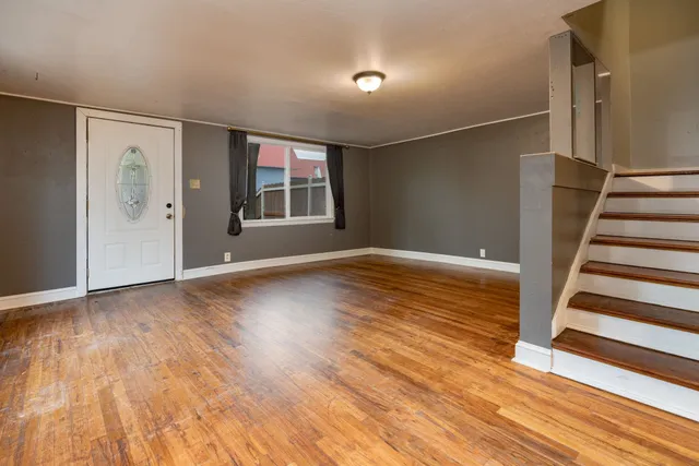 wooden floor in an empty room with a window