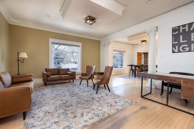 a living room with furniture a rug and a window