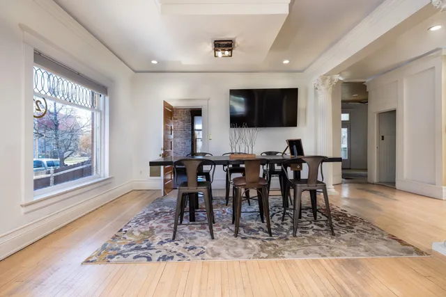 a view of a dining room with furniture window and wooden floor