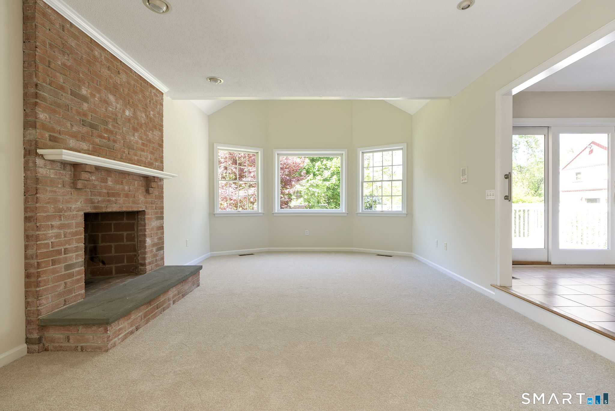 555 Waterville Road Avon, CT 06001 - Photo 17 of 40 a view of an empty room with window and fire place