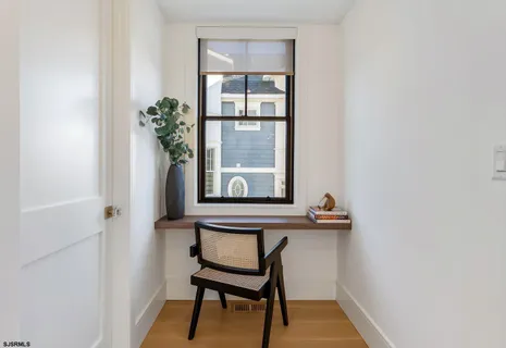a kitchen with a table chairs microwave and cabinets