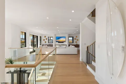 a view of hallway with stairs and wooden floor
