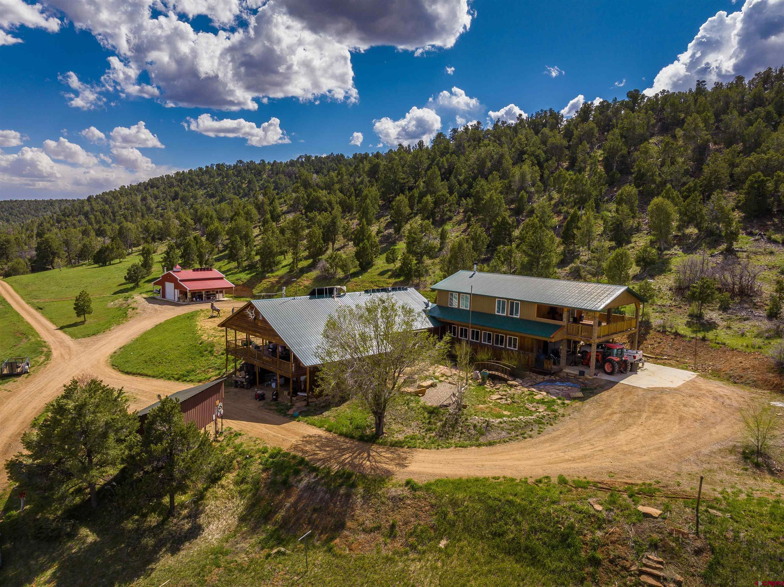 a view of a house with yard and lake view