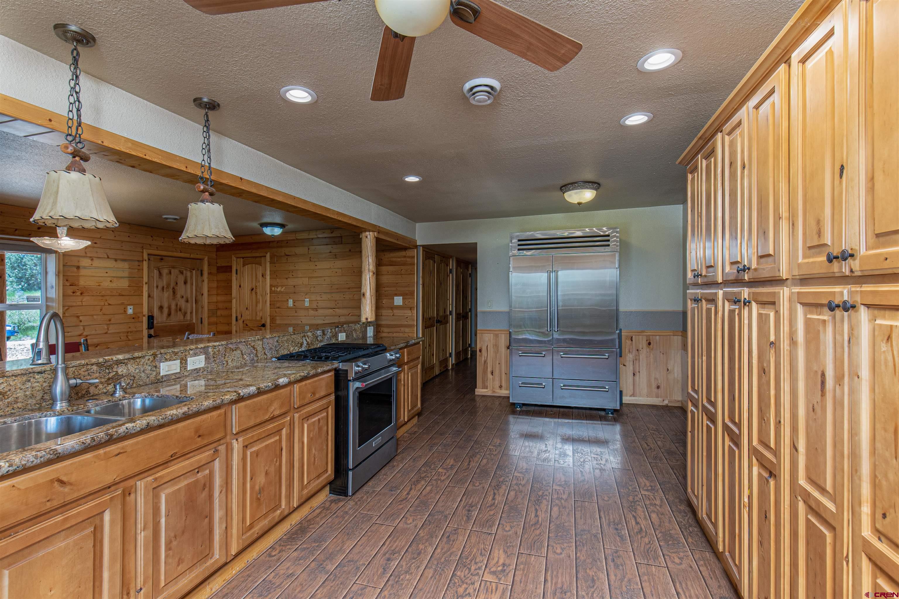 7049 County Road 105 Hesperus, CO 81326 - Photo 12 of 23 a kitchen with stainless steel appliances granite countertop a stove a sink and a refrigerator