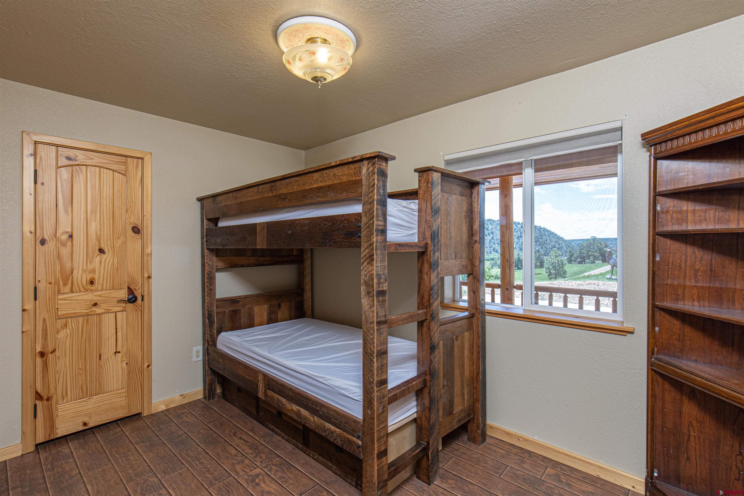 7049 County Road 105 Hesperus, CO 81326 - Photo 19 of 23 a bedroom with a bed and a window