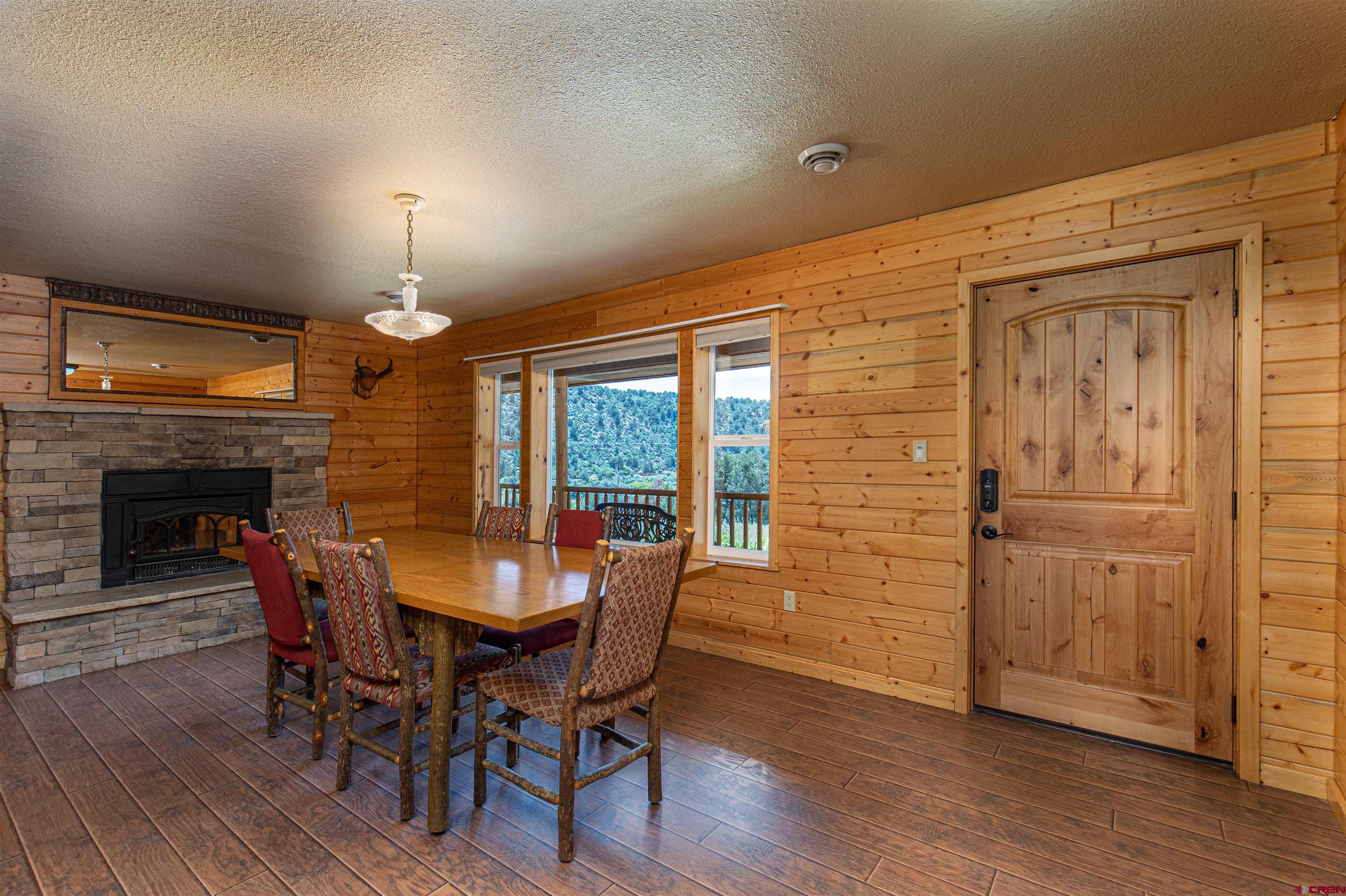 7049 County Road 105 Hesperus, CO 81326 - Photo 10 of 23 a view of a dining room with furniture window and wooden floor