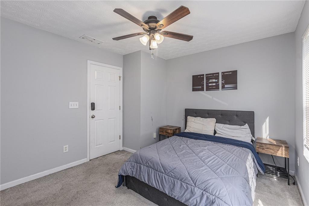 6536 Arbor Gate Drive Southwest, Unit 2 Mableton, GA 30126 - Photo 22 of 27 a bedroom with bed and window