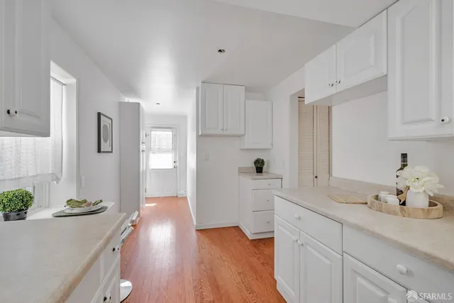 a view of a kitchen cabinets and wooden floor