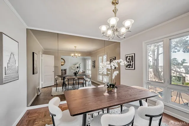 a view of a dining room with furniture and wooden floor