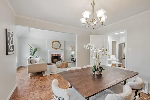 a view of a dining room with furniture and chandelier