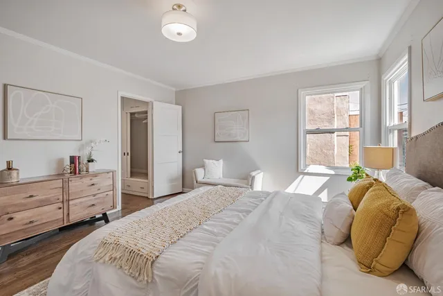 a bedroom with a bed and a chair