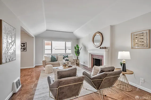 a living room with furniture a large window and a fireplace