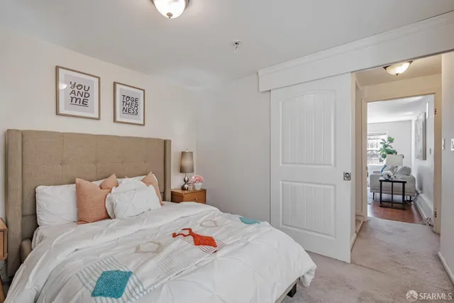 a bedroom with a bed and a dresser