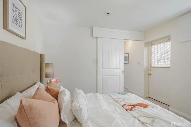 a bedroom with a bed and a window