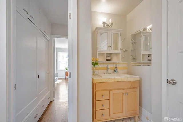 a bathroom with a granite countertop sink a toilet and a mirror
