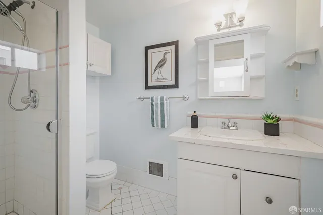 a bathroom with a shower toilet and sink