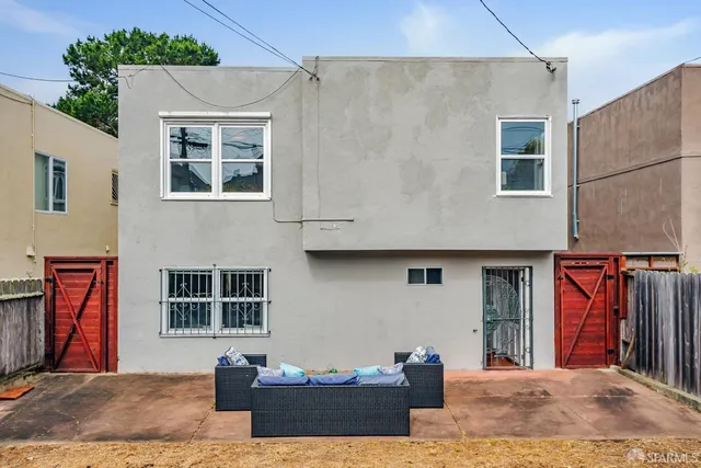a view of a backyard with plants and outdoor seating