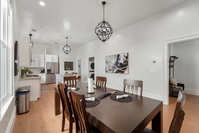 a kitchen with a cabinets a counter space dining furniture and a window