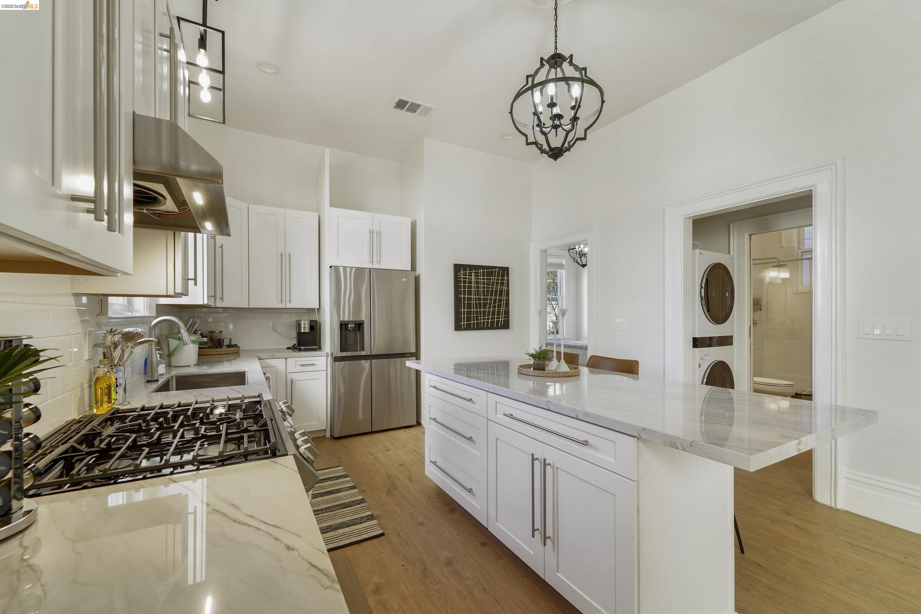 1662 14th Street Oakland, CA 94607 - Photo 19 of 57 a kitchen with a sink and a stove top oven