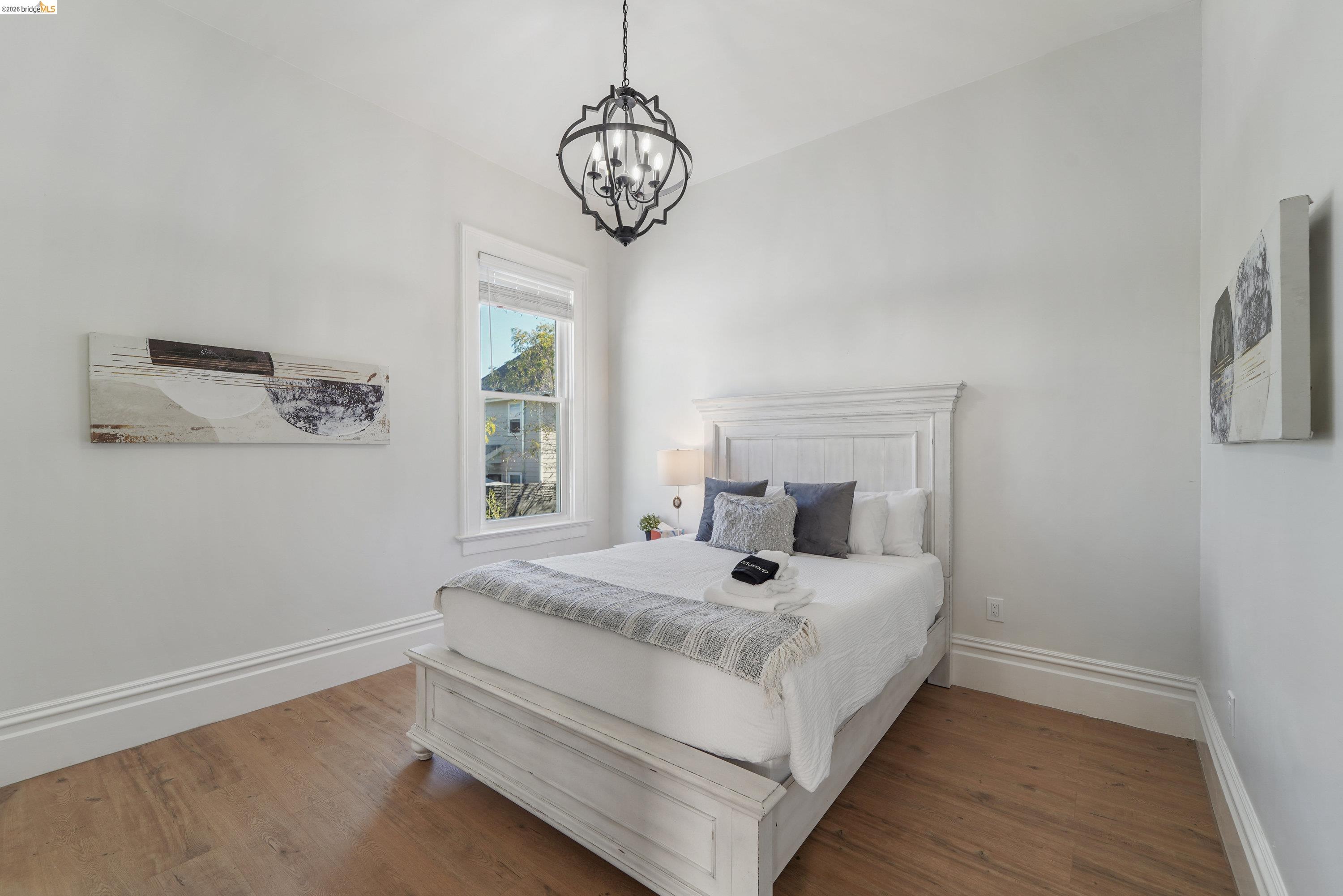 1662 14th Street Oakland, CA 94607 - Photo 20 of 57 a bedroom with a bed and a window