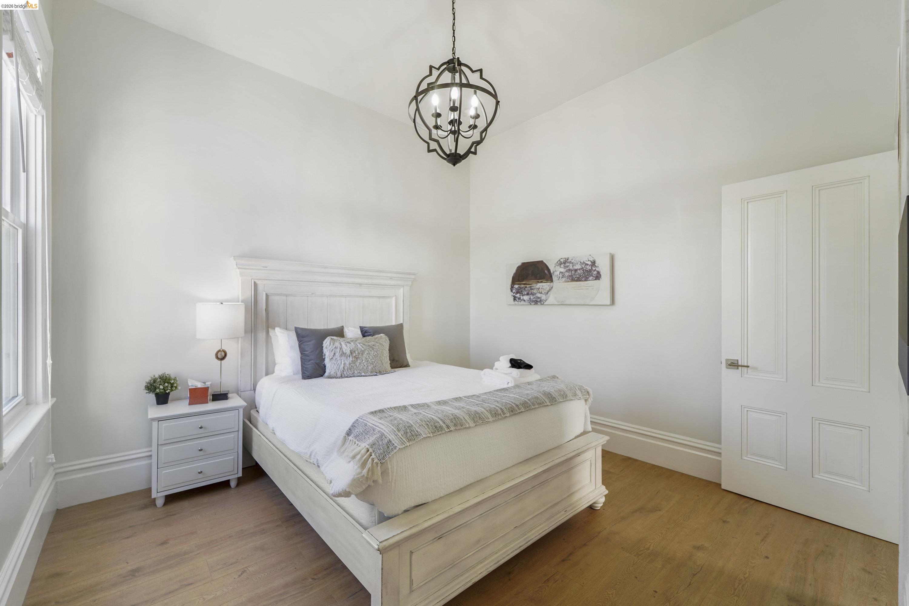 1662 14th Street Oakland, CA 94607 - Photo 23 of 57 a bedroom with a bed and a window