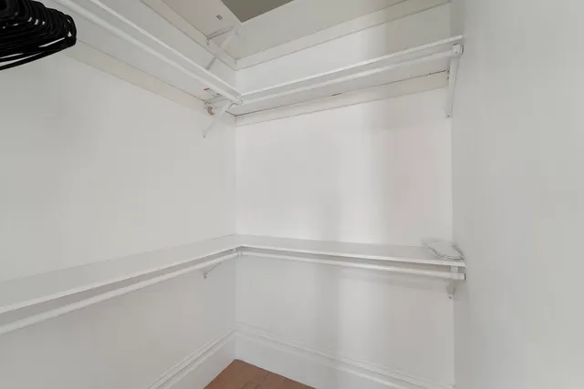 a bedroom with a bed and cabinets