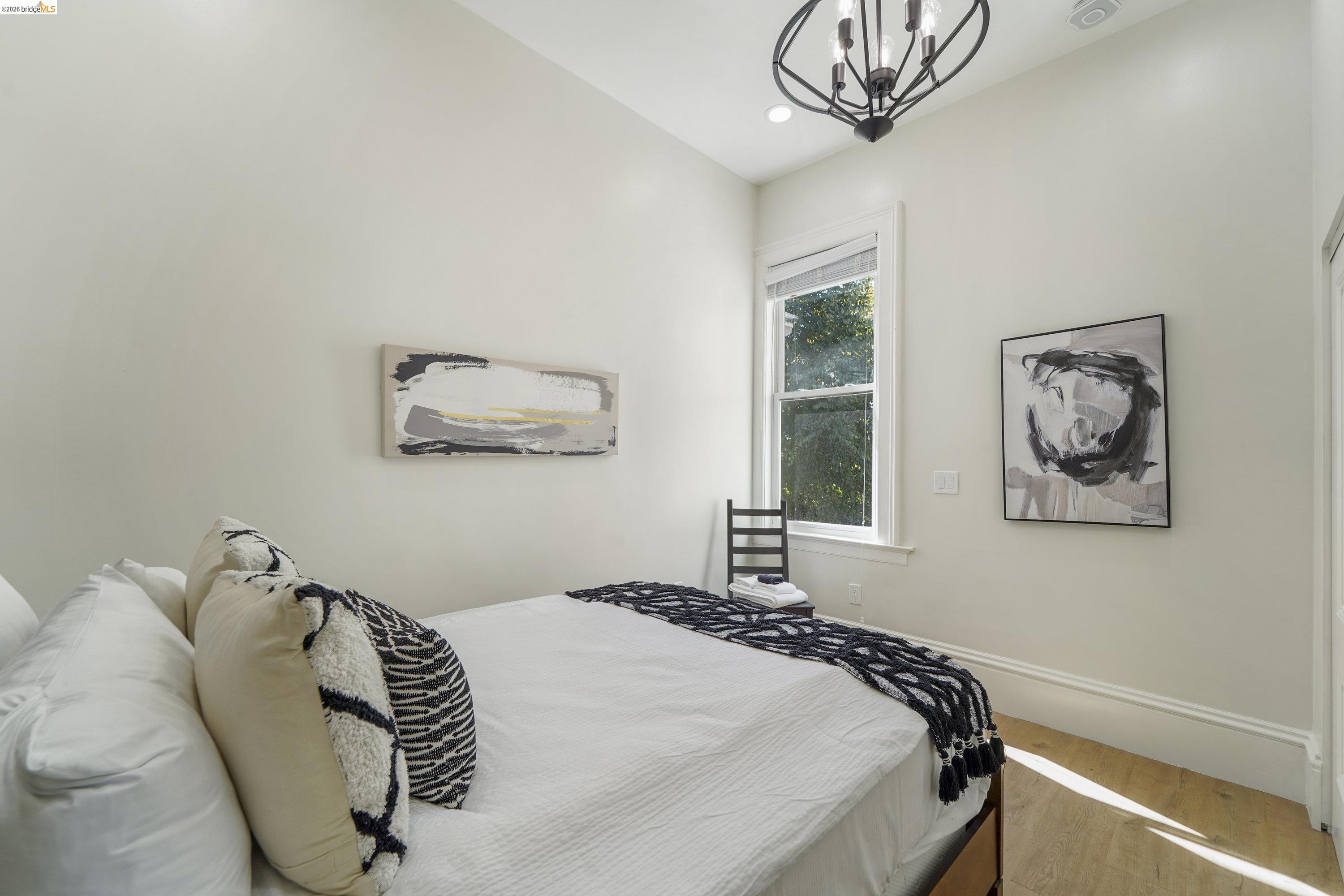 1662 14th Street Oakland, CA 94607 - Photo 29 of 57 a bedroom with a bed and a painting on the wall